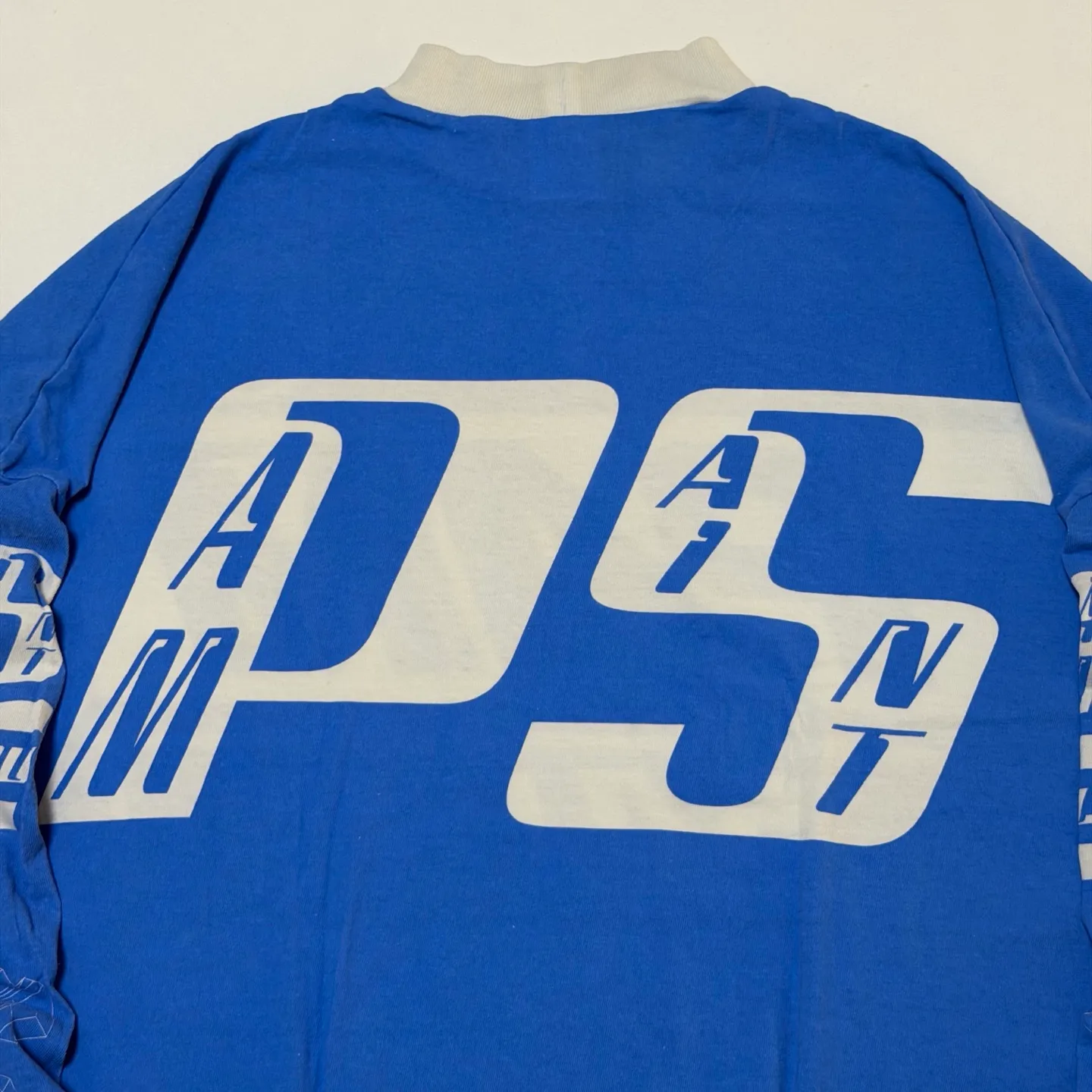 SAINT Mxxxxx Make the printing look distressed and white. Correct accessories. Customized co-branded model with P.A.M. wash mark.